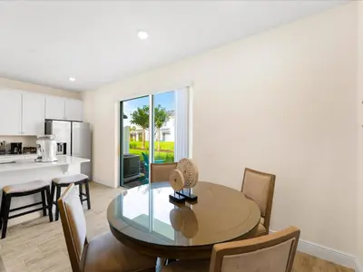 a kitchen and dining room with a table and chairs at Sunshine Villa Near Disney With Margaritaville Resort & Island H20 Waterpark Access - 2922Cl in Orlando