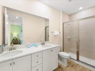 a bathroom with two sinks and a toilet and a shower at Sunshine Villa Near Disney With Margaritaville Resort & Island H20 Waterpark Access - 2922Cl in Orlando