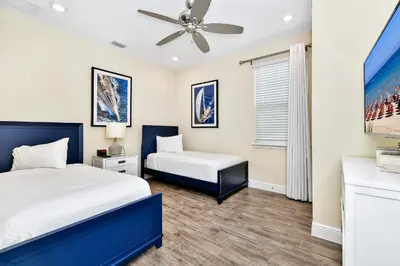 a bedroom with two beds and a ceiling fan at Sunrise Cottage With Private Pool Near Disney With Margaritaville Resort & Island H2O Access - 8017Su in Orlando