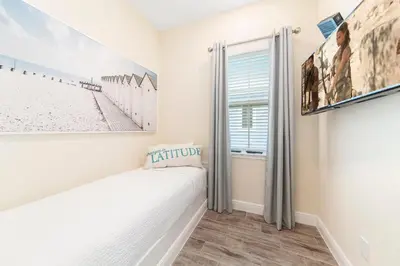 a bedroom with a bed and a window at Seven Saturdays Cottage Near Disney With Margaritaville Resort & Island H2O Access - 3032Sp in Orlando