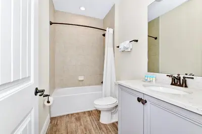 a white bathroom with a toilet and a sink at Pearly White Villa Near Disney With Margaritaville Resort & Island H2O Access - 3061Cs in Orlando