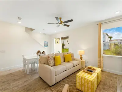 a living room with a couch and a table at Beautiful Florida Villa Near Disney With Margaritaville Resort & Island H20 Waterpark Access - 2939Cl in Orlando
