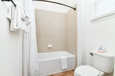 a bathroom with a white tub and a toilet at Crystal Cottage Near Disney With Margaritaville Resort & Island H2O Access - 8033Ls in Orlando