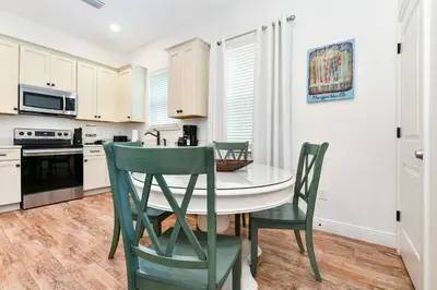a kitchen with a table and chairs in it at Crystal Cottage Near Disney With Margaritaville Resort & Island H2O Access - 8033Ls in Orlando