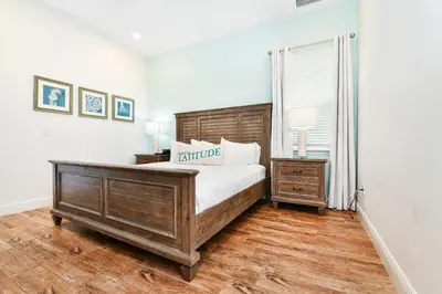 a bedroom with a wooden bed and a window at Crystal Cottage Near Disney With Margaritaville Resort & Island H2O Access - 8033Ls in Orlando