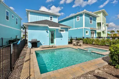 a swimming pool in front of a blue house at Sea Shell Blue Cottage Near Disney With Private Pool And Margaritaville Resort & Island H2O Access - 8039Kd in Orlando