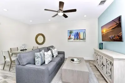 a living room with a couch and a ceiling fan at Tropical Green Villa Near Disney With Margaritaville Resort & Island H20 Access - 8142Cp in Kissimmee