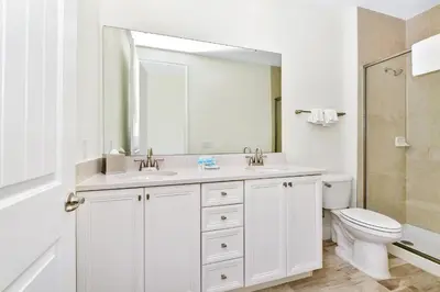 a white bathroom with a sink and a toilet at Calming Villa Near Disney With Margaritaville Resort And Island H20 Waterpark Access - 2914Cl in Orlando