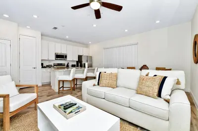 a living room with a white couch and a table at Calming Villa Near Disney With Margaritaville Resort And Island H20 Waterpark Access - 2914Cl in Orlando
