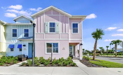 a pink house with a palm tree at Blissful Pink Villa Near Disney With Margaritaville Resort & Island H20 Access - 8103Cp in Orlando