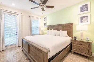 a bedroom with a bed and a ceiling fan at Vibrant Cottage With Private Pool Near Disney With Margaritaville Resort & Island H2O Access - 8043Kd in Orlando