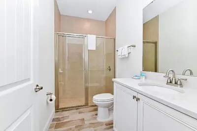 a bathroom with a shower and a toilet and a sink at Cool Cottage Near Disney With Margaritaville Resort & Island H20 Waterpark Access - 3184Cs in Orlando