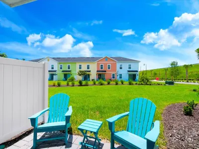 two blue chairs on a patio with a yard at Beach Blessing Villa Near Disney With Margaritaville Resort & Island H20 Waterpark Access - 3204Cs in Orlando