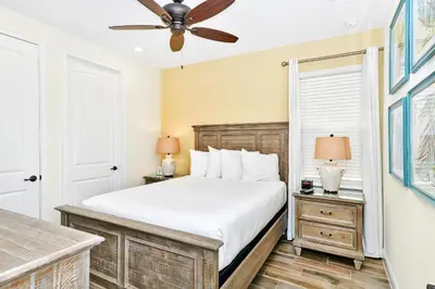 a bedroom with a bed and a ceiling fan at Beachy Daze Cottage Near Disney With Margaritaville Resort & Island H20 Waterpark Access - 2916Sr in Orlando
