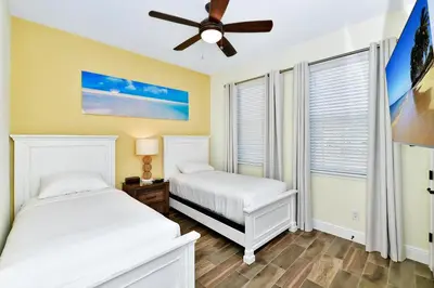 a bedroom with two beds and a ceiling fan at Tangerine Villa Near Disney With Margaritaville Resort And Island H20 Waterpark Access - 8178Cp in Orlando