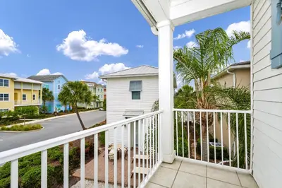 a balcony with a view of a street at Caraway Cove Cottage Near Disney With Margaritaville Resort & Island H2O Access - 8024Su in Orlando