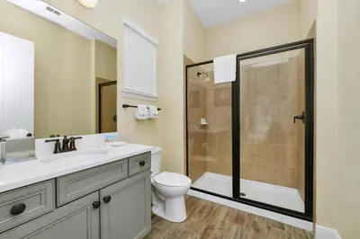a bathroom with a shower and a toilet and a sink at Caraway Cove Cottage Near Disney With Margaritaville Resort & Island H2O Access - 8024Su in Orlando