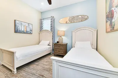 a bedroom with two beds and a night stand at Seashell Cream Cottage With Private Pool Near Disney With Margaritaville Resort & Island H2O Access - 8037St in Orlando