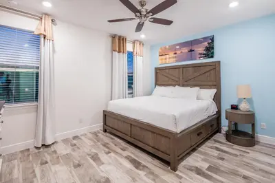 a bedroom with a bed and a ceiling fan at Pearly White Villa Near Disney With Margaritaville Resort & Island H20 Waterpark Access - 2924Cs in Orlando