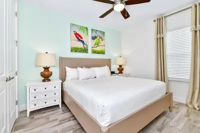 a bedroom with a bed and a ceiling fan at Breezy Blue Villa Near Disney With Margaritaville Resort Access - 3120Cs in Orlando