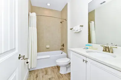 a white bathroom with a toilet and a sink at Blossom Villa Near Disney With Margaritaville Resort And Island H20 Waterpark Access - 2911Cl in Orlando