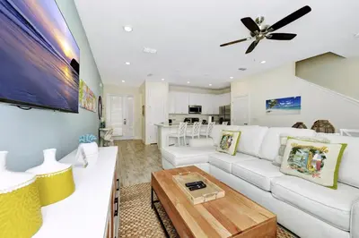 a living room with a white couch and a ceiling fan at Flip Flops & Fairytales Waterfront With Margaritaville Resort & Island H2O & Island H2O Access - 3021Cs in Orlando