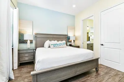 a bedroom with a large white bed and two lamps at Beautiful Cottage With Hot Tub Near Disney With Margaritaville Resort & Island H2O Access - 8053Ls in Orlando