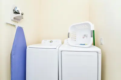 a white refrigerator with a scale on top of it at Beautiful Cottage With Hot Tub Near Disney With Margaritaville Resort & Island H2O Access - 8053Ls in Orlando