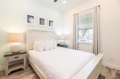 a white bedroom with a bed and a window at Dreamy Cottage With Private Pool Near Disney And Margaritaville Resort & Island H2O Amenities - 8019Kd in Orlando