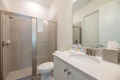 a bathroom with a toilet and a sink and a shower at Dreamy Cottage With Private Pool Near Disney And Margaritaville Resort & Island H2O Amenities - 8019Kd in Orlando
