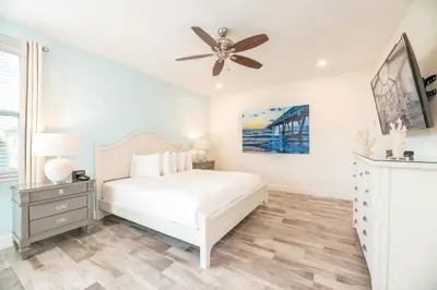a white bedroom with a bed and a ceiling fan at Dreamy Cottage With Private Pool Near Disney And Margaritaville Resort & Island H2O Amenities - 8019Kd in Orlando
