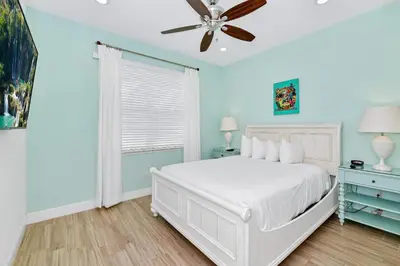 a bedroom with a white bed and a ceiling fan at Luxury Cottage Near Disney With Private Pool & Margaritaville Resort And Island H20 Waterpark Access - 3088Ph in Orlando