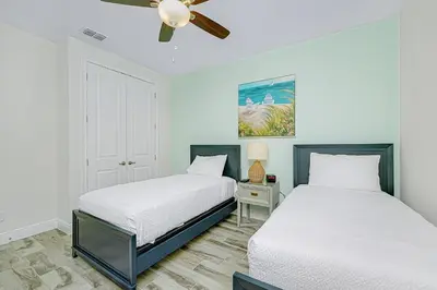 a bedroom with two beds and a ceiling fan at Beautiful Villa Near Disney With Margaritaville Resort & Island H20 Waterpark Access - 2976Cs in Orlando