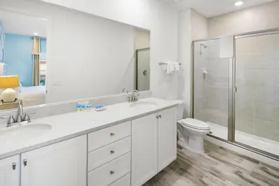 a bathroom with two sinks and a shower and a toilet at Lovely Villa Near Disney With Margaritaville Resort & Island H20 Access - 8201Su in Orlando