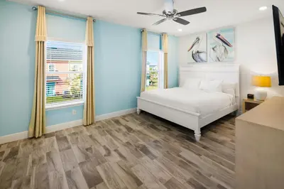 a bedroom with a bed and a ceiling fan at Lovely Villa Near Disney With Margaritaville Resort & Island H20 Access - 8201Su in Orlando