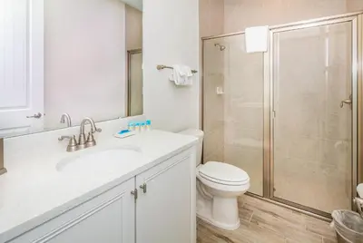 a white bathroom with a toilet and a shower at Beautiful Villa Near Disney With Margaritaville Resort & Island H20 Waterpark Access - 2933Cs in Orlando