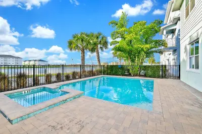 a swimming pool in front of a building at Palm Tree Paradise Cottage Private Pool Near Disney With Margaritaville Resort & Island H20 Access - 8109Su in Orlando