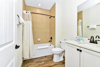 a white bathroom with a toilet and a sink at Perfect Family Villa Near Disney With Margaritaville Resort & Island H20 Waterpark Access - 3168Cs in Orlando