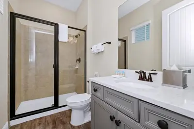 a bathroom with a shower and a toilet and a sink at Aqua Blue Cottage Near Disney With Margaritaville Resort & Island H20 Waterpark Access - 2930Sr in Orlando