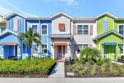 a row of colorful houses with palm trees at Pink Bliss Villa Near Disney With Margaritaville Resort & Island H20 Access - 3205Cs in Orlando