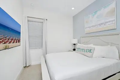 a white bedroom with a white bed and a window at Orange Blossom Special Cottage Near Disney With Private Hot Tub & Island H20 Waterpark Access - 3071Pi in Orlando