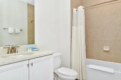 a bathroom with a toilet and a sink and a shower at Sand Delight Near Disney With Margaritaville Resort & Island H20 Waterpark Access - 3152Cs in Orlando