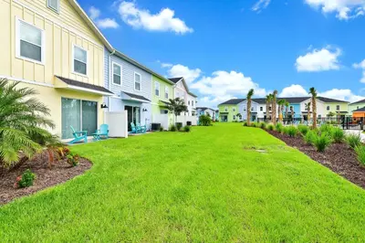 a yard in front of a row of houses at Sand Delight Near Disney With Margaritaville Resort & Island H20 Waterpark Access - 3152Cs in Orlando