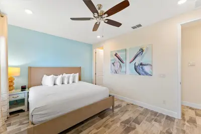 a bedroom with a bed and a ceiling fan at Alluring Villa Near Disney With Margaritaville Resort & Island H2O Access - 3057Cs in Orlando