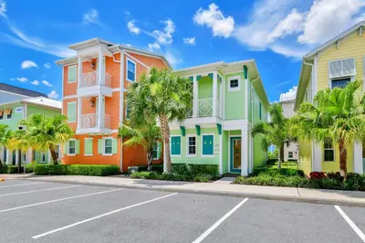 a row of houses in a street with palm trees at Pina Cabana Cottage Near Disney With Margaritaville Resort & Island H2O Access - 3070Kl in Orlando