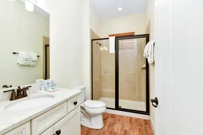 a bathroom with a toilet sink and a shower at Pina Cabana Cottage Near Disney With Margaritaville Resort & Island H2O Access - 3070Kl in Orlando