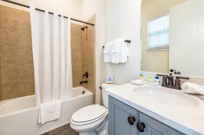 a bathroom with a sink and a toilet and a shower at Sail Away! Beautiful Cottage With Private Hot Tub Near Disney With Margaritaville Resort & Island H2O Access - 3045Sp in Orlando
