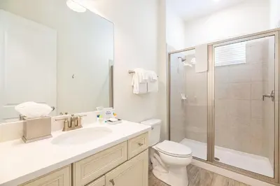 a bathroom with a toilet and a sink and a shower at Kokomo Cottage Near Disney With Margaritaville Resort & Island H2O Access - 8034Su in Orlando