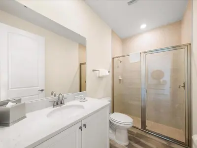 a bathroom with a toilet and a sink and a shower at Breezy Blue Villa Near Disney With Margaritaville Resort And Island H20 Waterpark Access - 2902Cl in Orlando