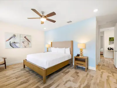 a bedroom with a bed and a ceiling fan at Breezy Blue Villa Near Disney With Margaritaville Resort And Island H20 Waterpark Access - 2902Cl in Orlando